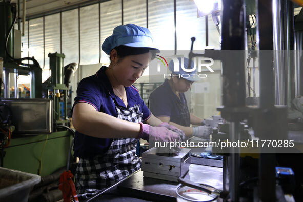 A worker produces metal parts at a workshop of a precision machinery manufacturing enterprise in Binzhou, China, on November 12, 2024. 