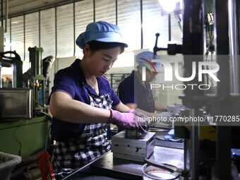 A worker produces metal parts at a workshop of a precision machinery manufacturing enterprise in Binzhou, China, on November 12, 2024. (