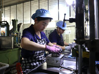 A worker produces metal parts at a workshop of a precision machinery manufacturing enterprise in Binzhou, China, on November 12, 2024. (