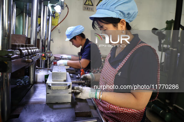 A worker produces metal parts at a workshop of a precision machinery manufacturing enterprise in Binzhou, China, on November 12, 2024. 