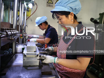 A worker produces metal parts at a workshop of a precision machinery manufacturing enterprise in Binzhou, China, on November 12, 2024. (