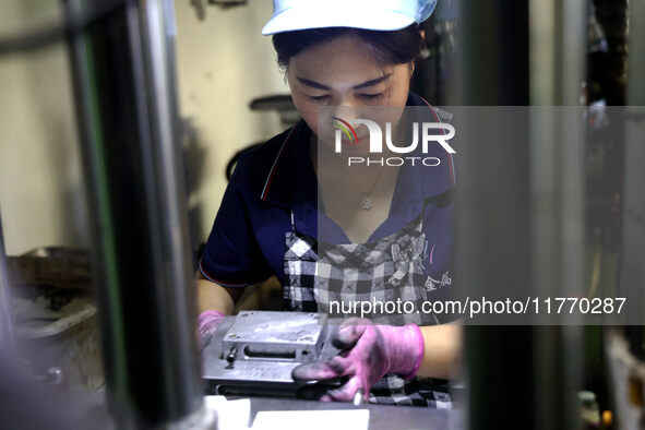 A worker produces metal parts at a workshop of a precision machinery manufacturing enterprise in Binzhou, China, on November 12, 2024. 