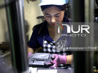 A worker produces metal parts at a workshop of a precision machinery manufacturing enterprise in Binzhou, China, on November 12, 2024. (