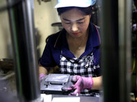 A worker produces metal parts at a workshop of a precision machinery manufacturing enterprise in Binzhou, China, on November 12, 2024. (