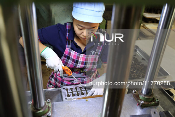 A worker produces metal parts at a workshop of a precision machinery manufacturing enterprise in Binzhou, China, on November 12, 2024. 