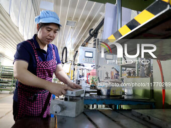 A worker produces metal parts at a workshop of a precision machinery manufacturing enterprise in Binzhou, China, on November 12, 2024. (