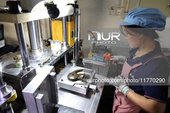 A worker produces metal parts at a workshop of a precision machinery manufacturing enterprise in Binzhou, China, on November 12, 2024. 