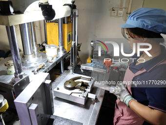 A worker produces metal parts at a workshop of a precision machinery manufacturing enterprise in Binzhou, China, on November 12, 2024. (