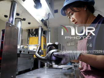 A worker produces metal parts at a workshop of a precision machinery manufacturing enterprise in Binzhou, China, on November 12, 2024. (