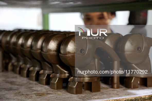 A worker produces metal parts at a workshop of a precision machinery manufacturing enterprise in Binzhou, China, on November 12, 2024. 