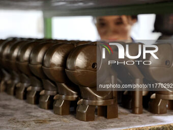 A worker produces metal parts at a workshop of a precision machinery manufacturing enterprise in Binzhou, China, on November 12, 2024. (