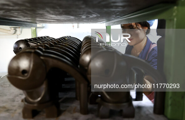 A worker produces metal parts at a workshop of a precision machinery manufacturing enterprise in Binzhou, China, on November 12, 2024. 