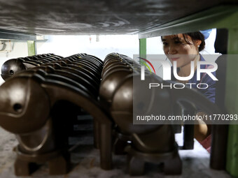 A worker produces metal parts at a workshop of a precision machinery manufacturing enterprise in Binzhou, China, on November 12, 2024. (