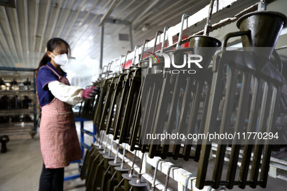 A worker produces metal parts at a workshop of a precision machinery manufacturing enterprise in Binzhou, China, on November 12, 2024. 