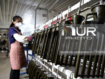 A worker produces metal parts at a workshop of a precision machinery manufacturing enterprise in Binzhou, China, on November 12, 2024. (