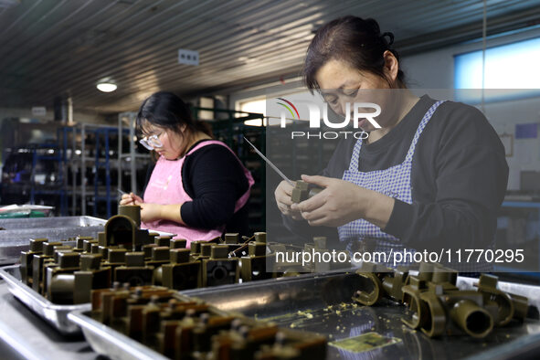 A worker produces metal parts at a workshop of a precision machinery manufacturing enterprise in Binzhou, China, on November 12, 2024. 