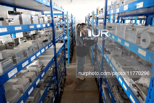 A worker produces metal parts at a workshop of a precision machinery manufacturing enterprise in Binzhou, China, on November 12, 2024. 