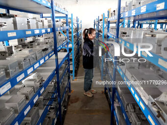 A worker produces metal parts at a workshop of a precision machinery manufacturing enterprise in Binzhou, China, on November 12, 2024. (