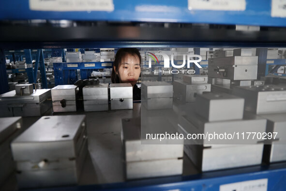 A worker produces metal parts at a workshop of a precision machinery manufacturing enterprise in Binzhou, China, on November 12, 2024. 