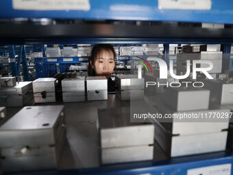 A worker produces metal parts at a workshop of a precision machinery manufacturing enterprise in Binzhou, China, on November 12, 2024. (