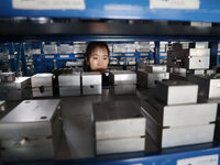 A worker produces metal parts at a workshop of a precision machinery manufacturing enterprise in Binzhou, China, on November 12, 2024. (