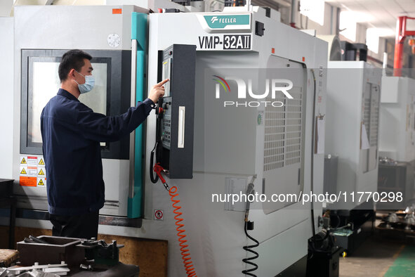 A worker produces metal parts at a workshop of a precision machinery manufacturing enterprise in Binzhou, China, on November 12, 2024. 