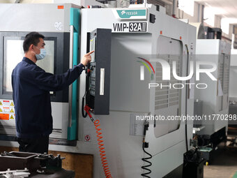 A worker produces metal parts at a workshop of a precision machinery manufacturing enterprise in Binzhou, China, on November 12, 2024. (