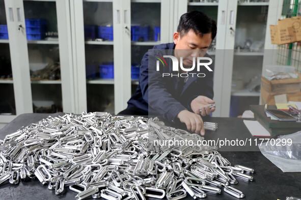 A worker produces metal parts at a workshop of a precision machinery manufacturing enterprise in Binzhou, China, on November 12, 2024. 