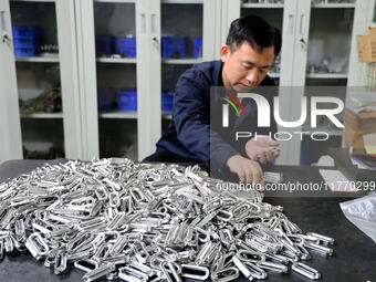 A worker produces metal parts at a workshop of a precision machinery manufacturing enterprise in Binzhou, China, on November 12, 2024. (