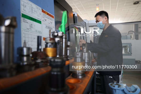 A worker produces metal parts at a workshop of a precision machinery manufacturing enterprise in Binzhou, China, on November 12, 2024. 