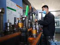 A worker produces metal parts at a workshop of a precision machinery manufacturing enterprise in Binzhou, China, on November 12, 2024. (