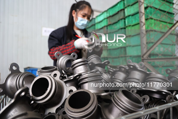 A worker produces metal parts at a workshop of a precision machinery manufacturing enterprise in Binzhou, China, on November 12, 2024. 