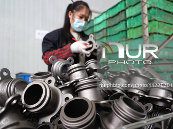 A worker produces metal parts at a workshop of a precision machinery manufacturing enterprise in Binzhou, China, on November 12, 2024. (