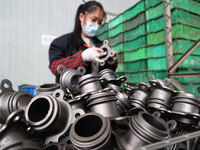 A worker produces metal parts at a workshop of a precision machinery manufacturing enterprise in Binzhou, China, on November 12, 2024. (