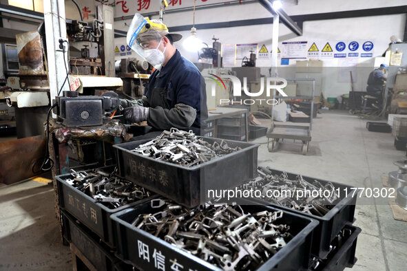 A worker produces metal parts at a workshop of a precision machinery manufacturing enterprise in Binzhou, China, on November 12, 2024. 