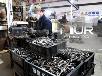 A worker produces metal parts at a workshop of a precision machinery manufacturing enterprise in Binzhou, China, on November 12, 2024. (