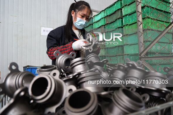 A worker produces metal parts at a workshop of a precision machinery manufacturing enterprise in Binzhou, China, on November 12, 2024. 