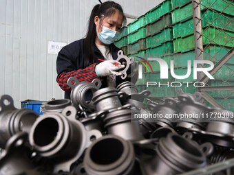 A worker produces metal parts at a workshop of a precision machinery manufacturing enterprise in Binzhou, China, on November 12, 2024. (