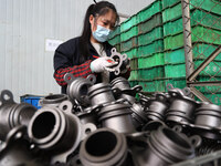 A worker produces metal parts at a workshop of a precision machinery manufacturing enterprise in Binzhou, China, on November 12, 2024. (