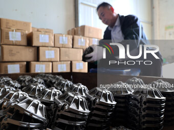 A worker produces metal parts at a workshop of a precision machinery manufacturing enterprise in Binzhou, China, on November 12, 2024. (