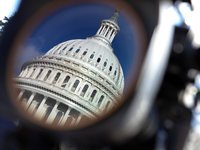 The dome of the U.S. Capitol buildling is seen reflected in a video camera lens before a GOP press conference on the steps of the U.S. Capit...