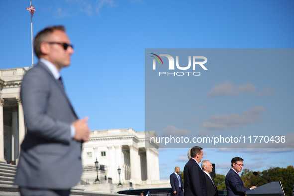 A law enforcement officer stands guard as House Speaker Mike Johnson (R-LA), speaks at a GOP press conference on the steps of the U.S. Capit...