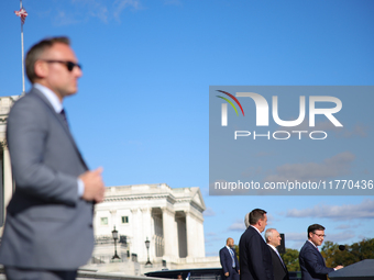 A law enforcement officer stands guard as House Speaker Mike Johnson (R-LA), speaks at a GOP press conference on the steps of the U.S. Capit...