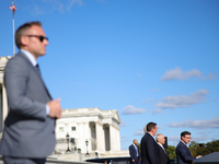 A law enforcement officer stands guard as House Speaker Mike Johnson (R-LA), speaks at a GOP press conference on the steps of the U.S. Capit...