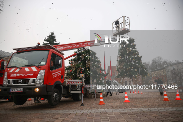 Workers are erecting a Christmas Tree at the Podgorski Square in Krakow, Poland on November 12th, 2024. 