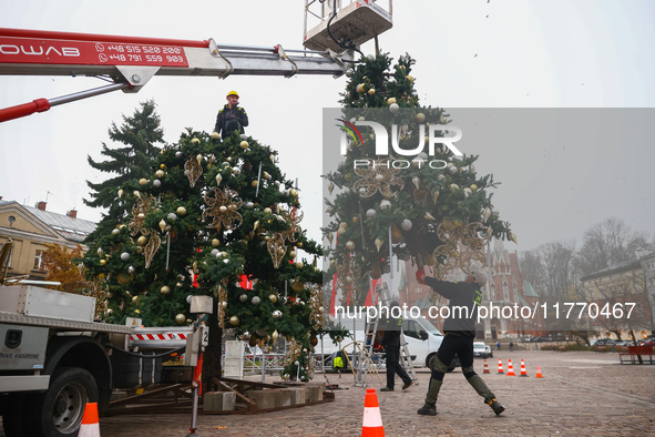 Workers are erecting a Christmas Tree at the Podgorski Square in Krakow, Poland on November 12th, 2024. 