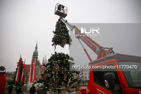 Workers are erecting a Christmas Tree at the Podgorski Square in Krakow, Poland on November 12th, 2024. 