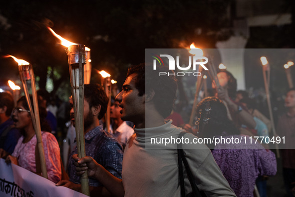 The Bangladesh Students Union holds a torch procession protesting the murder of a female ready-made garment worker and demanding justice at...