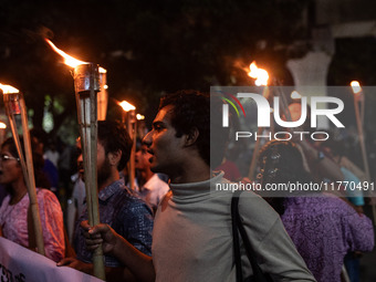 The Bangladesh Students Union holds a torch procession protesting the murder of a female ready-made garment worker and demanding justice at...