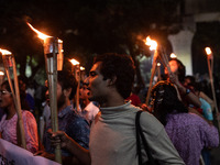 The Bangladesh Students Union holds a torch procession protesting the murder of a female ready-made garment worker and demanding justice at...